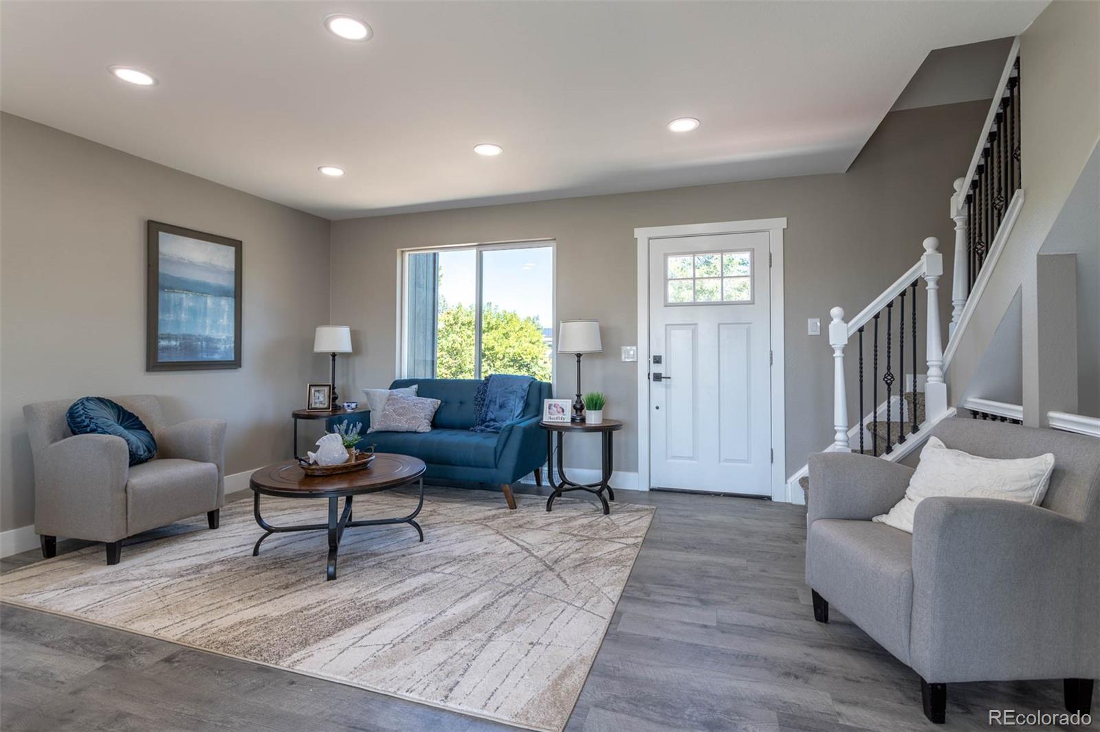 4465 South Eagle Circle Aurora, CO 80015 - Photo 2 of 26 a living room with furniture and a wooden floor