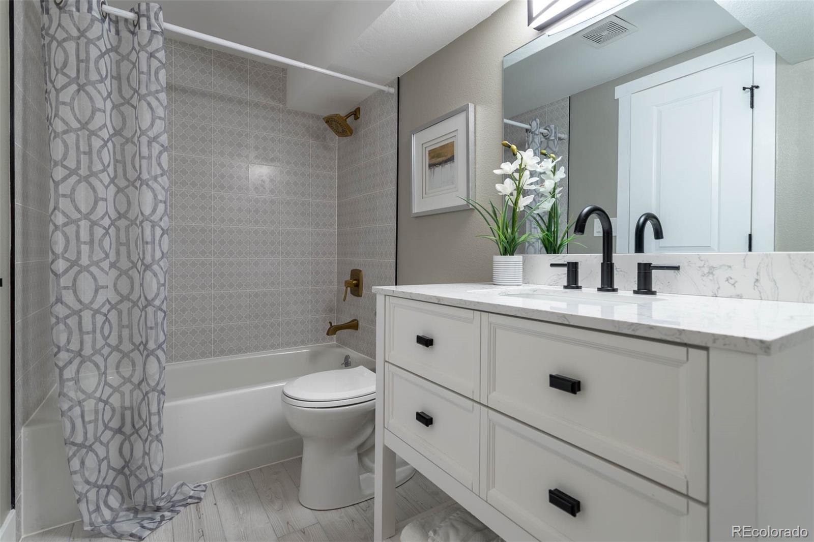 4465 South Eagle Circle Aurora, CO 80015 - Photo 23 of 26 a bathroom with a sink a toilet and shower