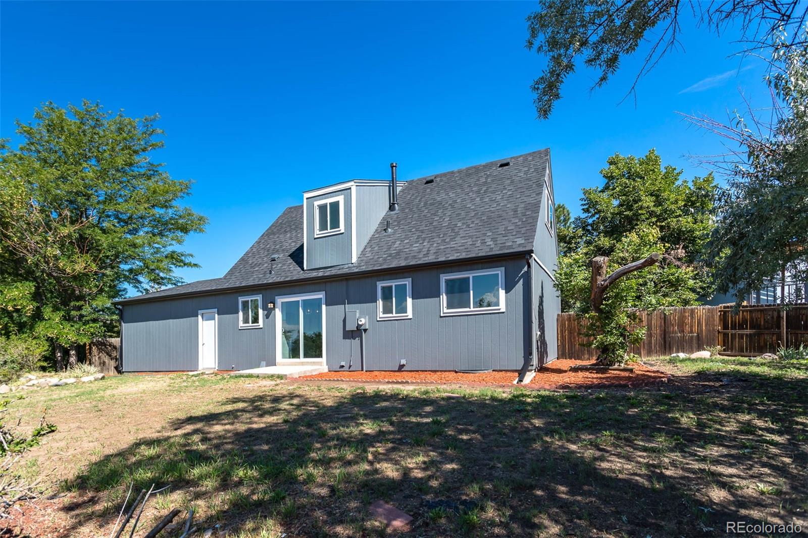 4465 South Eagle Circle Aurora, CO 80015 - Photo 24 of 26 a front view of a house with a garden