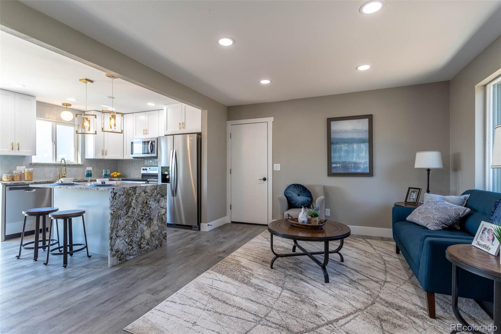 4465 South Eagle Circle Aurora, CO 80015 - Photo 4 of 26 a living room with furniture and kitchen view