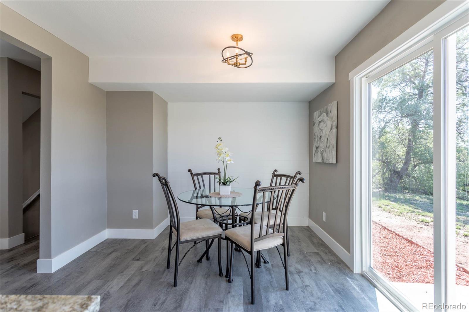 4465 South Eagle Circle Aurora, CO 80015 - Photo 10 of 26 a view of a dining room with furniture window and wooden floor
