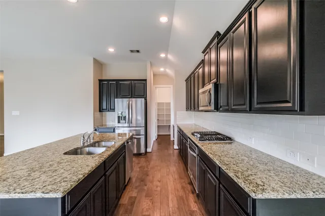 a kitchen with granite countertop stainless steel appliances lots of counter top space