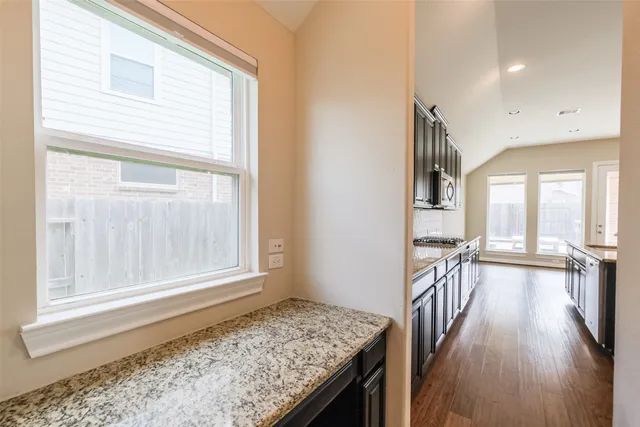 a view of entryway and hall with wooden floor