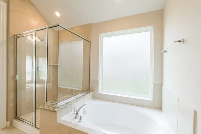 a bathroom with a bathtub and a shower