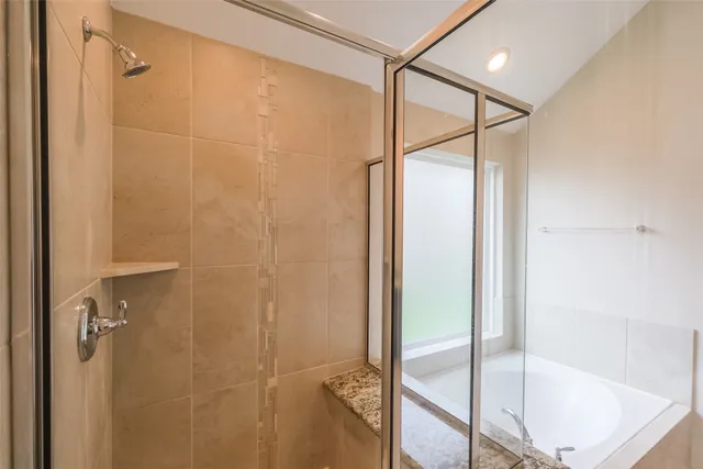 a bathroom with a glass shower door