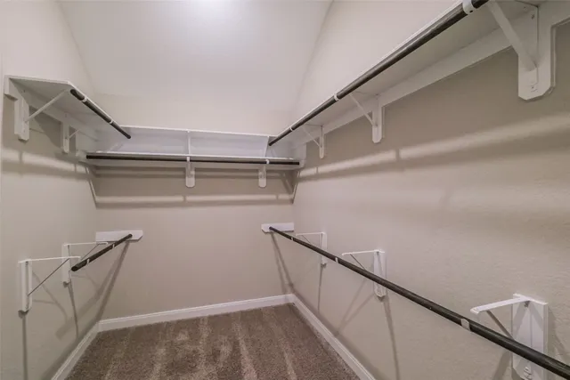 a view of storage and utility room with racks on the wall