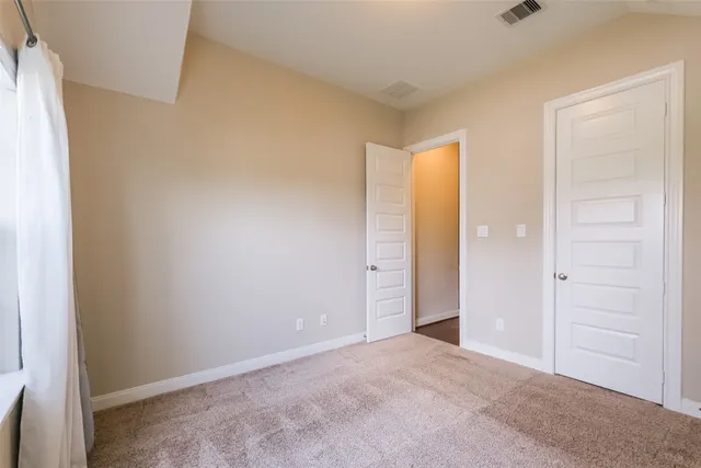 an empty room with closet area