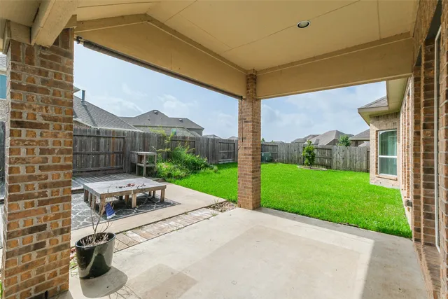 a view of a patio with a table and chairs