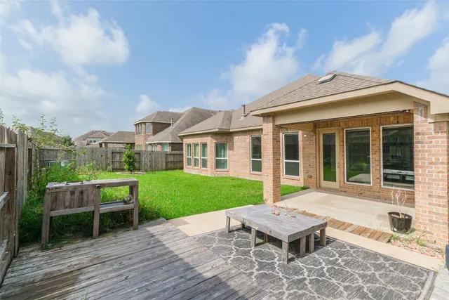 a view of a house with backyard and a sitting area