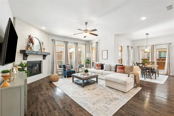 a living room with fireplace furniture and a flat screen tv