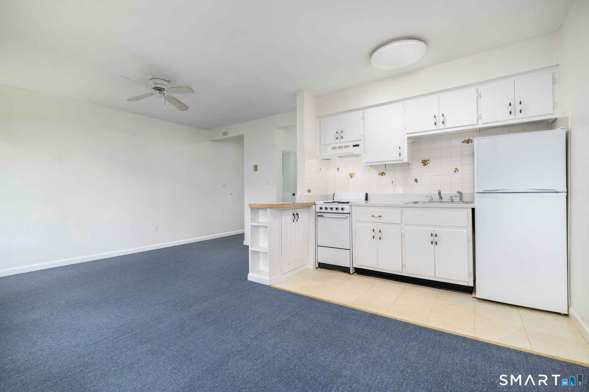 445 Hope Street, Unit 2 Stamford, CT 06906 - Photo 2 of 9 a kitchen with cabinets a sink a stove a refrigerator and white cabinets