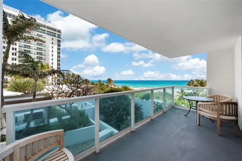 a view of a balcony with chairs