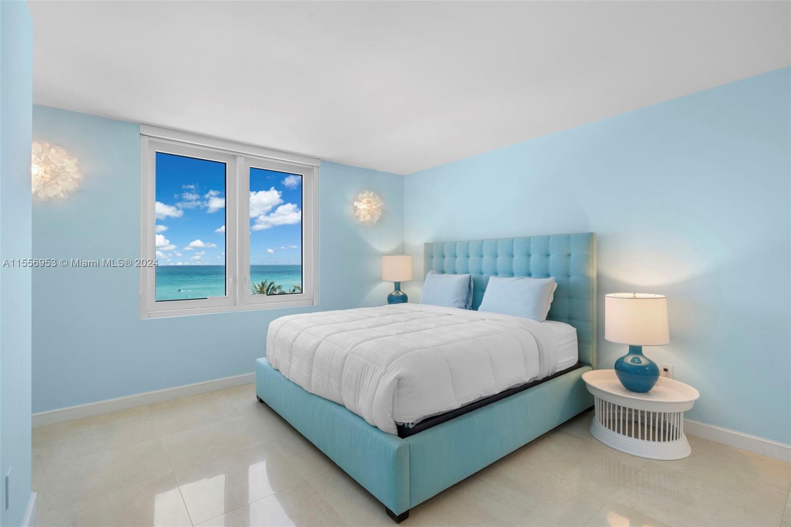 2301 Collins Avenue, Unit 410 Miami Beach, FL 33139 - Photo 16 of 42 a bedroom with a bed lamp and window