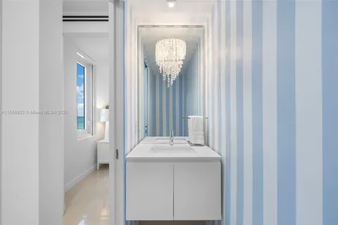 a bathroom with a sink a mirror and shower