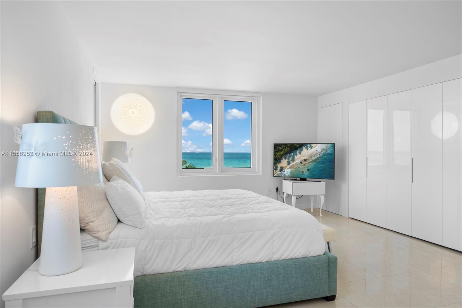 2301 Collins Avenue, Unit 410 Miami Beach, FL 33139 - Photo 23 of 42 a bedroom with a bed and a flat tv screen on dresser