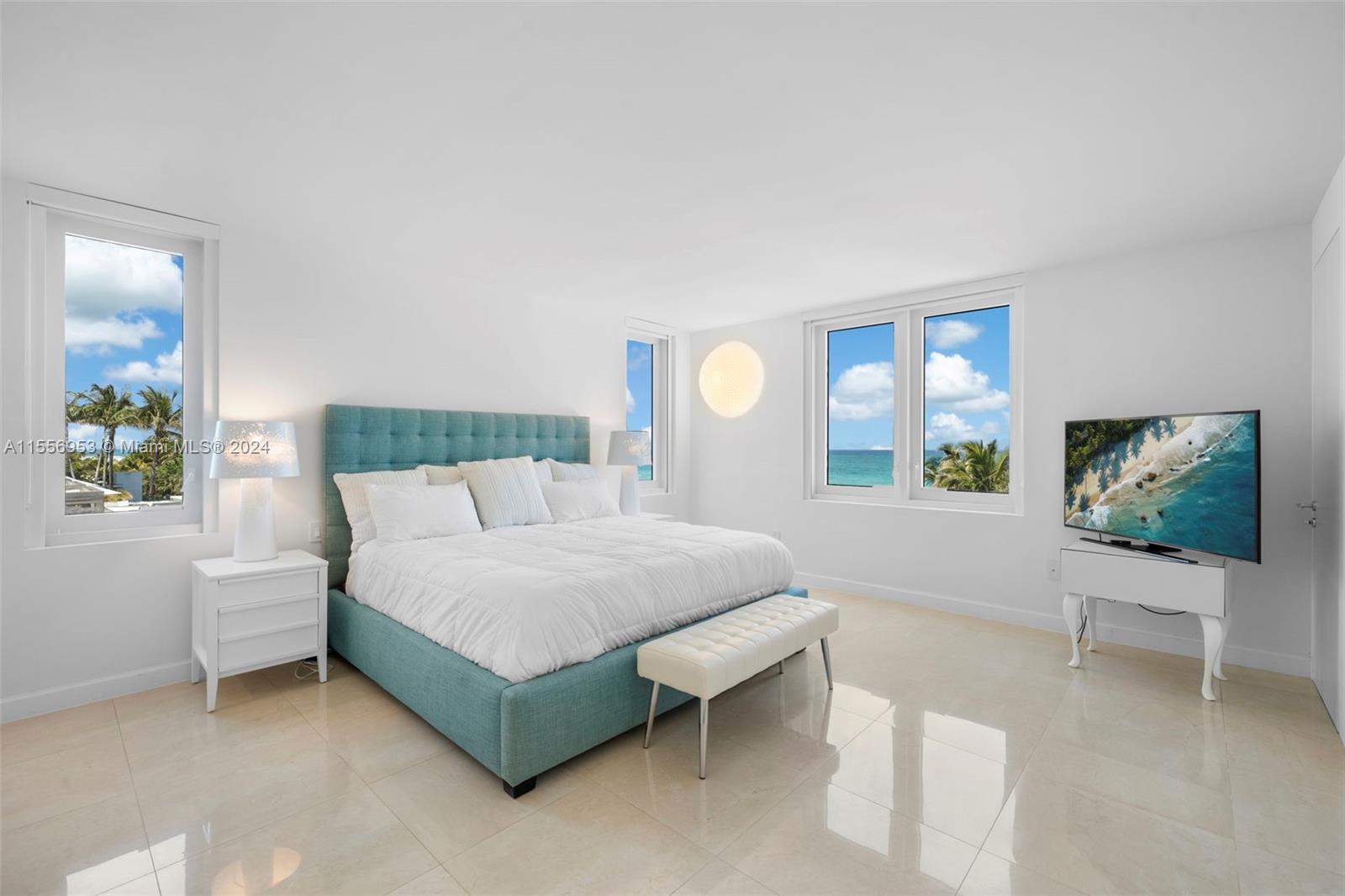 2301 Collins Avenue, Unit 410 Miami Beach, FL 33139 - Photo 24 of 42 a spacious bedroom with a bed and large windows