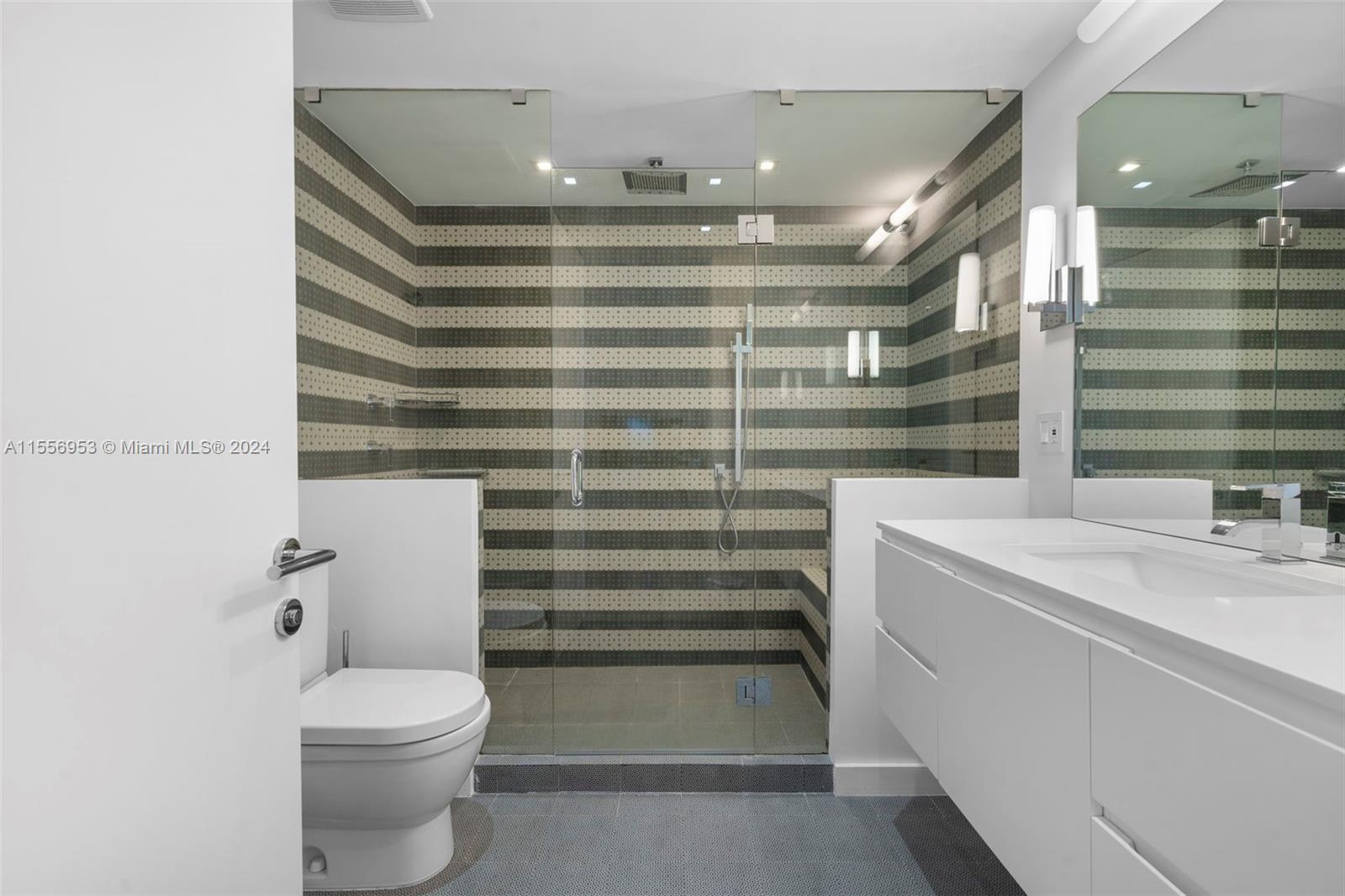 2301 Collins Avenue, Unit 410 Miami Beach, FL 33139 - Photo 27 of 42 a bathroom with a sink a toilet and shower