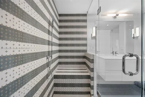 a bathroom with a tub and shower