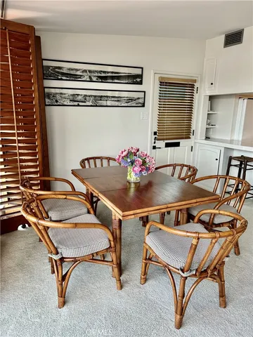 a living room with a table and chairs