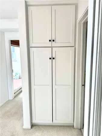 a living room with furniture and paintings