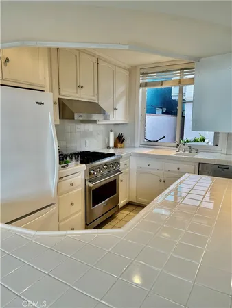 a kitchen with a sink cabinets and window