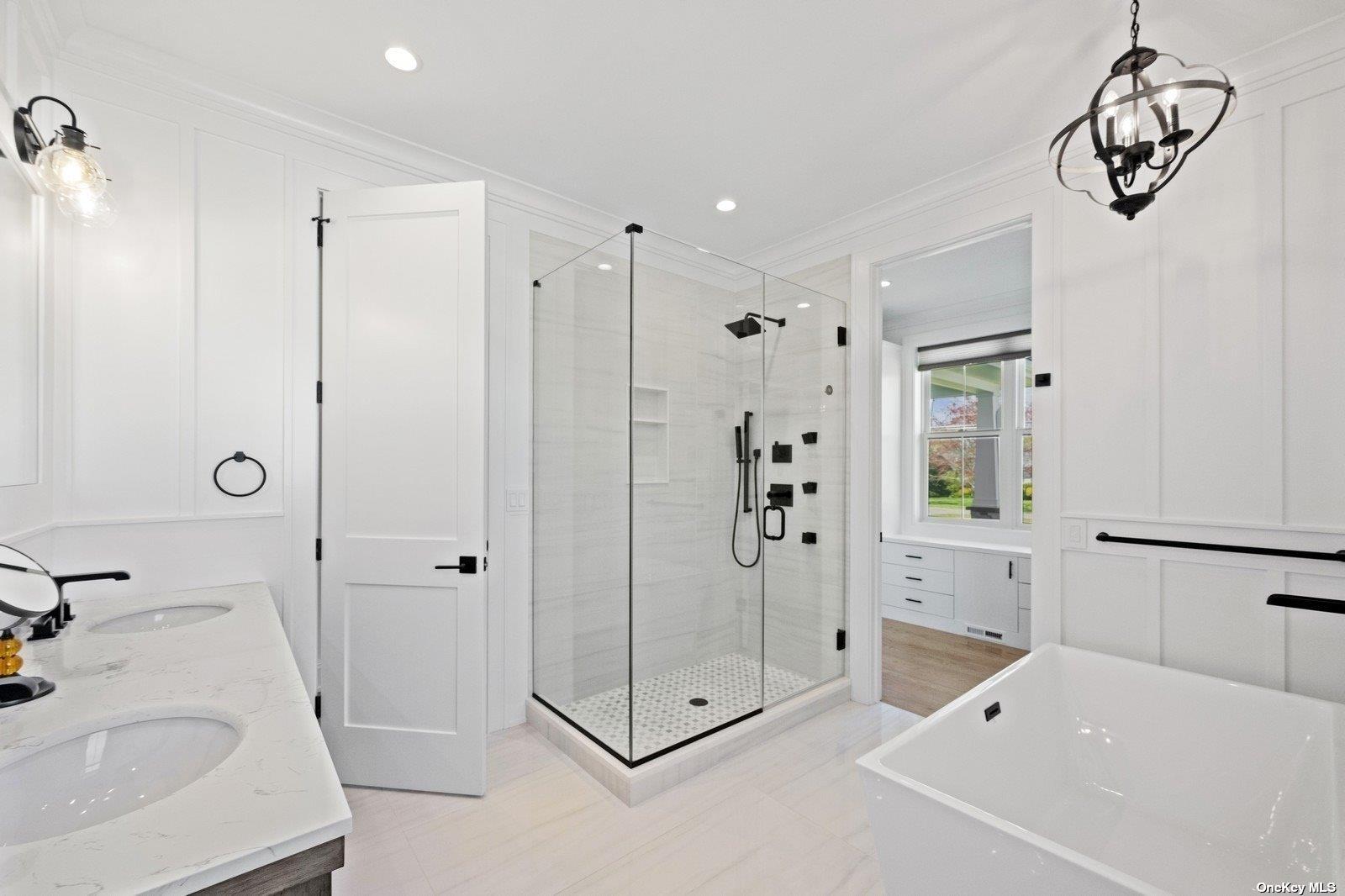 910 Glenn Road Southold, NY 11971 - Photo 15 of 33 a bathroom with a tub sink and mirror