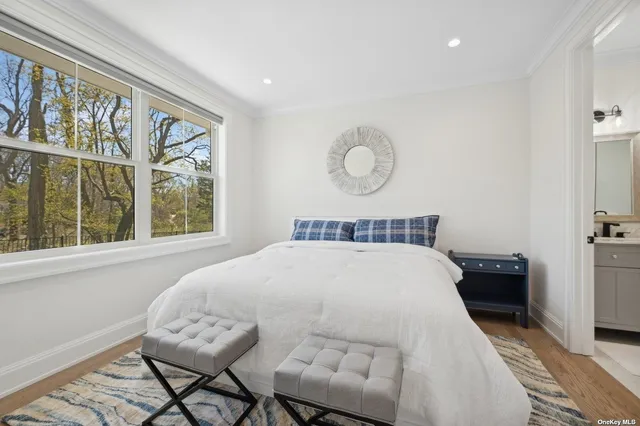 a bedroom with a large bed and a window