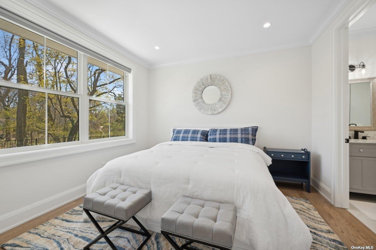 910 Glenn Road Southold, NY 11971 - Photo 16 of 33 a bedroom with a large bed and a window