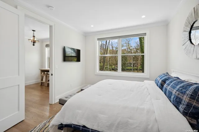 a bedroom with a bed and a flat tv screen