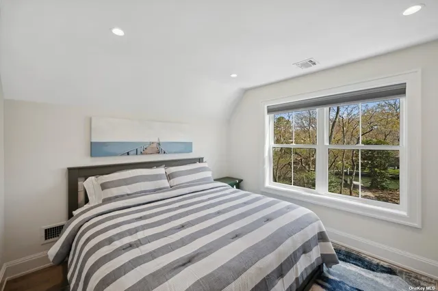 a bedroom with a large bed and a window