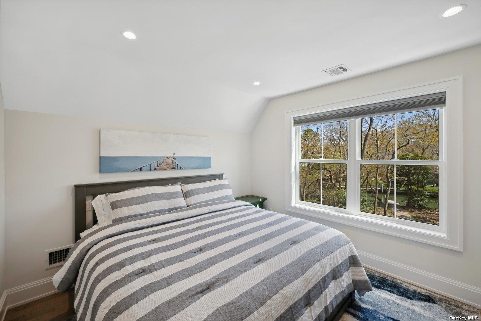 910 Glenn Road Southold, NY 11971 - Photo 21 of 33 a bedroom with a large bed and a window