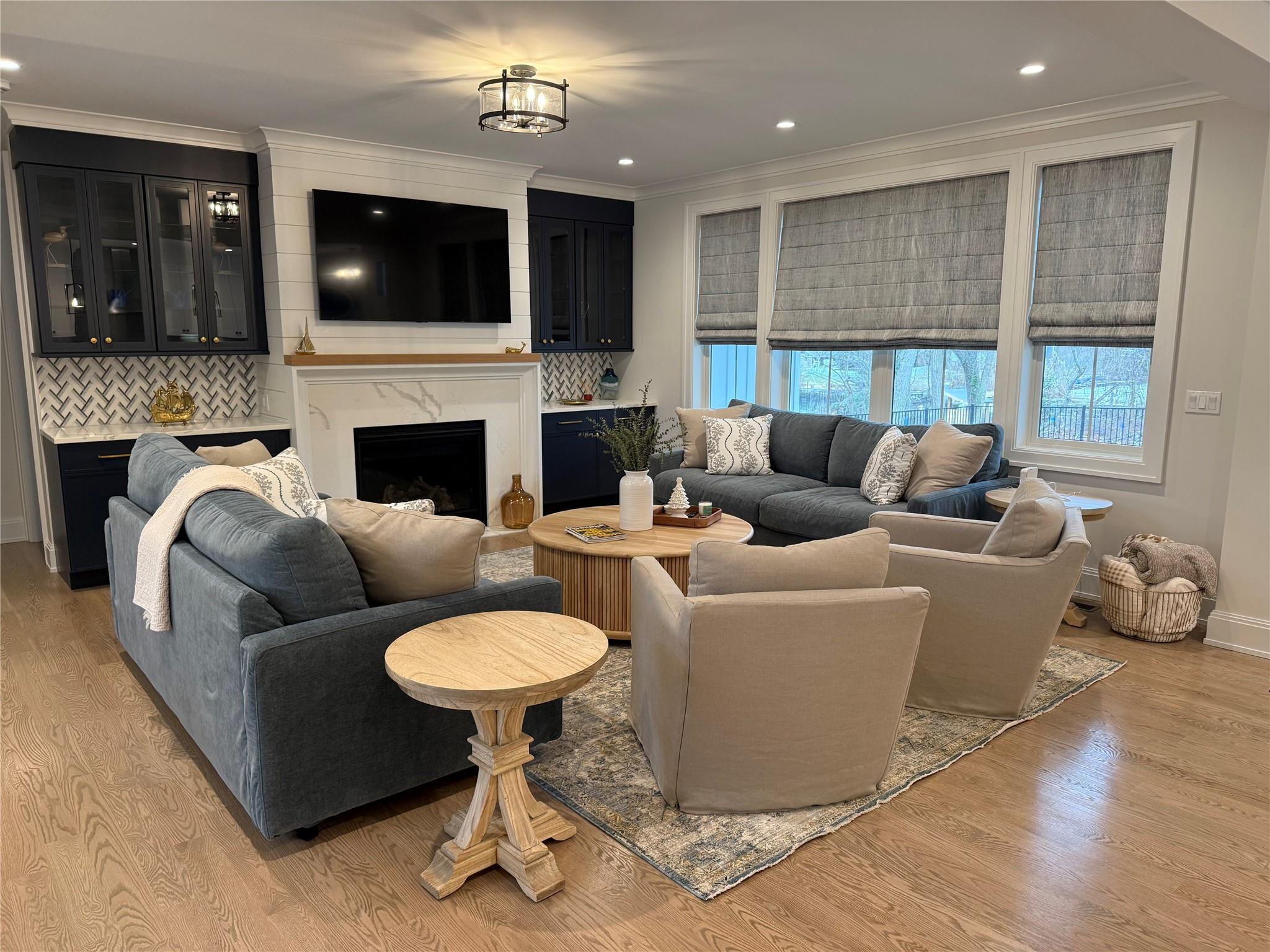 910 Glenn Road Southold, NY 11971 - Photo 4 of 33 a living room with furniture a fireplace and a flat screen tv