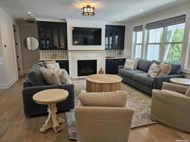 a living room with furniture a flat screen tv and a fireplace