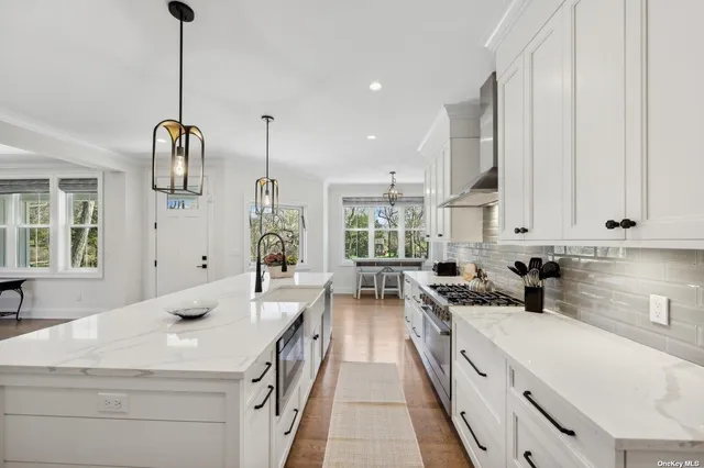 a kitchen with stainless steel appliances a sink stove and cabinets