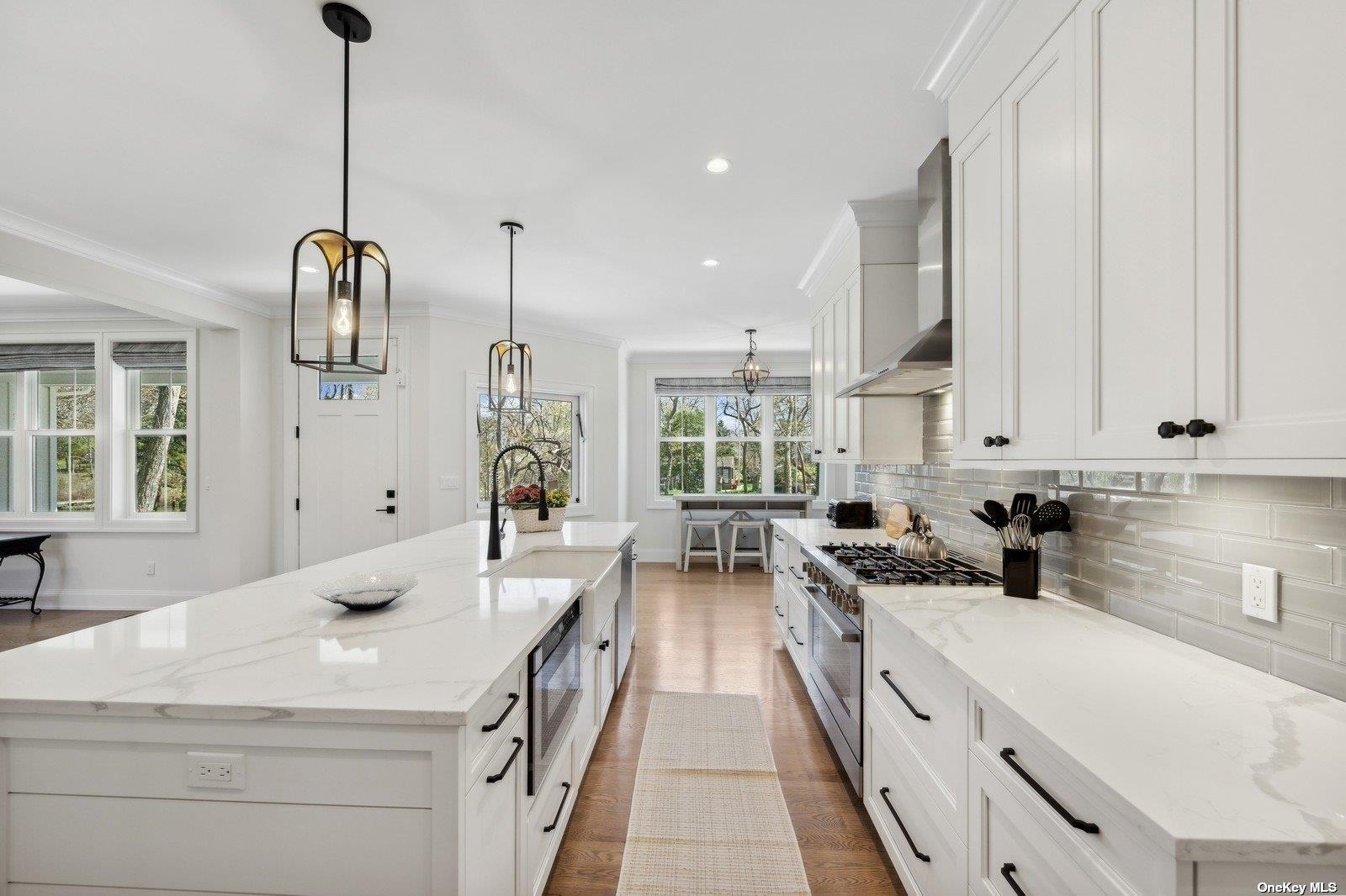 910 Glenn Road Southold, NY 11971 - Photo 6 of 33 a kitchen with stainless steel appliances a sink stove and cabinets