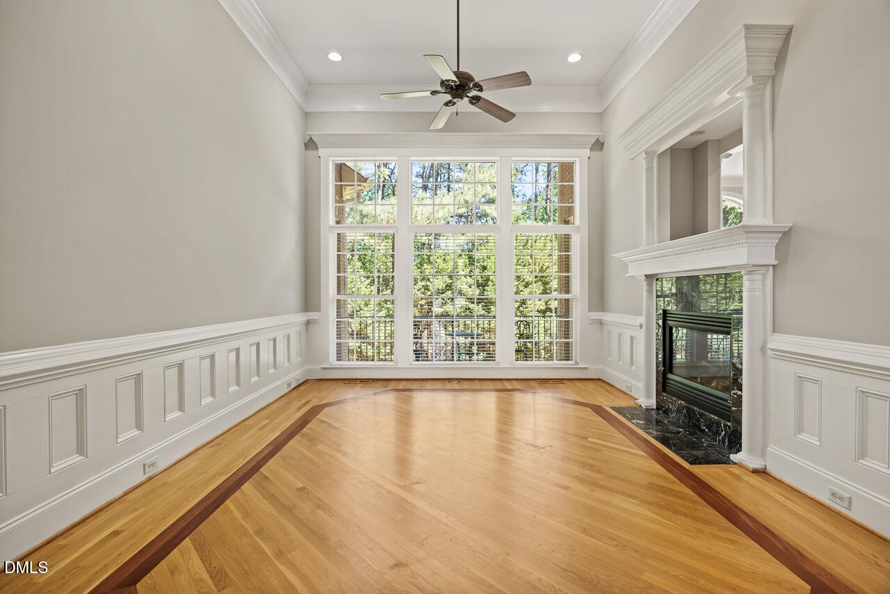 4004 Frontenac Court Apex, NC 27539 - Photo 11 of 61 a view of an empty room with a window and wooden floor