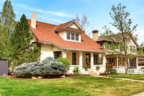 a front view of a house with a yard table and chairs