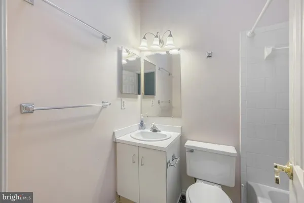 a bathroom with a sink a toilet and mirror