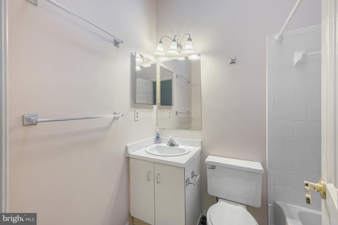 7222 Brookfalls Terrace Baltimore, MD 21209 - Photo 13 of 17 a bathroom with a sink a toilet and mirror