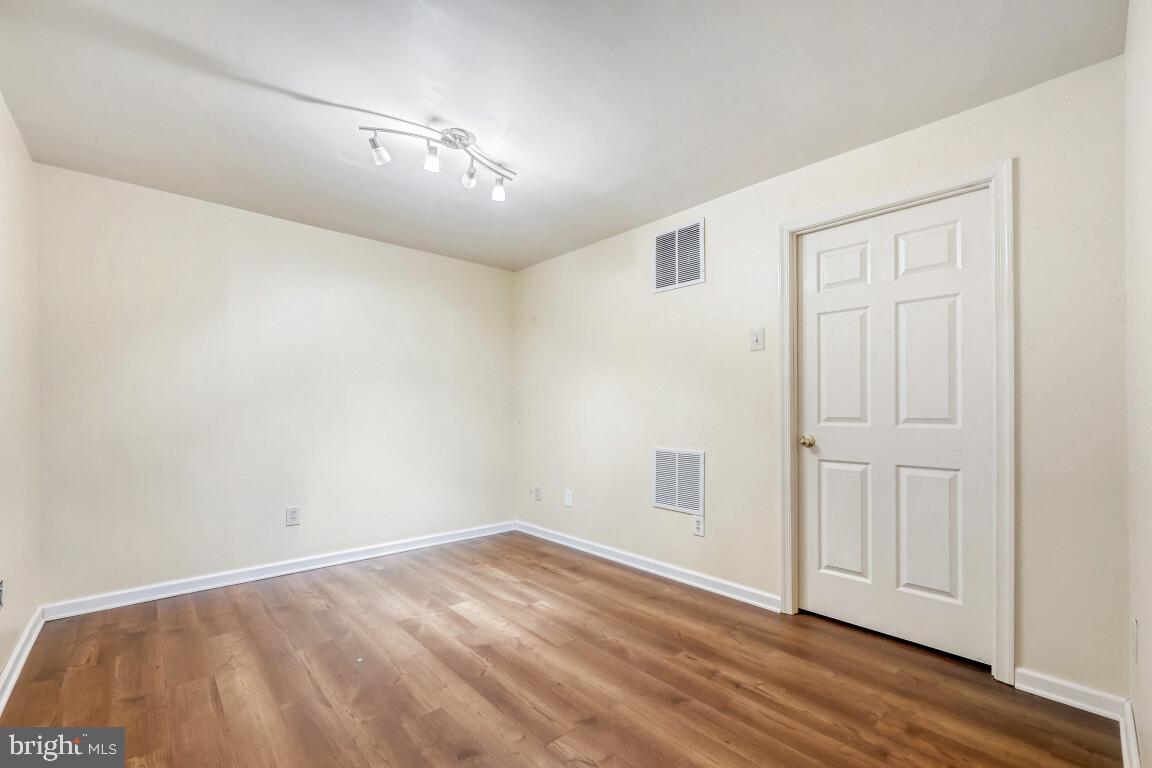 7222 Brookfalls Terrace Baltimore, MD 21209 - Photo 14 of 17 an empty room with wooden floor and windows