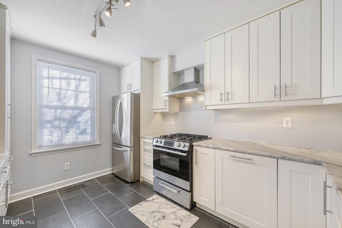7222 Brookfalls Terrace Baltimore, MD 21209 - Photo 2 of 17 a kitchen with white cabinets and appliances