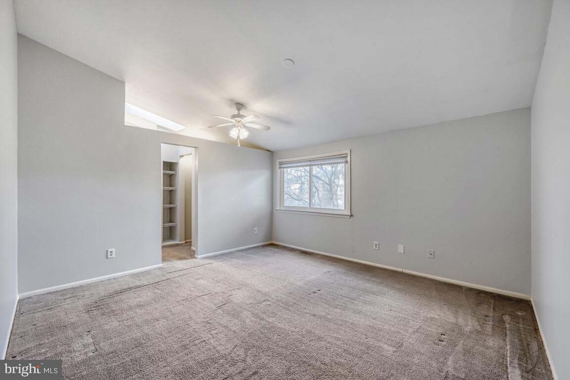 7222 Brookfalls Terrace Baltimore, MD 21209 - Photo 7 of 17 an empty room with windows and chandelier fan