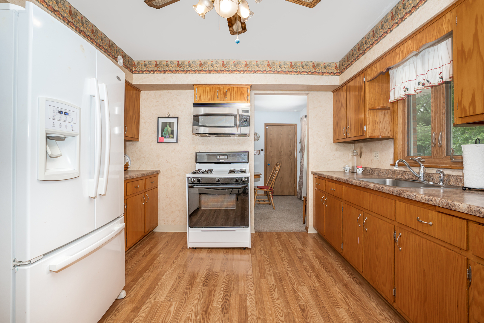 11025 Bryant Road Mokena, IL 60448 - Photo 8 of 21 a kitchen with stainless steel appliances a stove cabinets and wooden floor