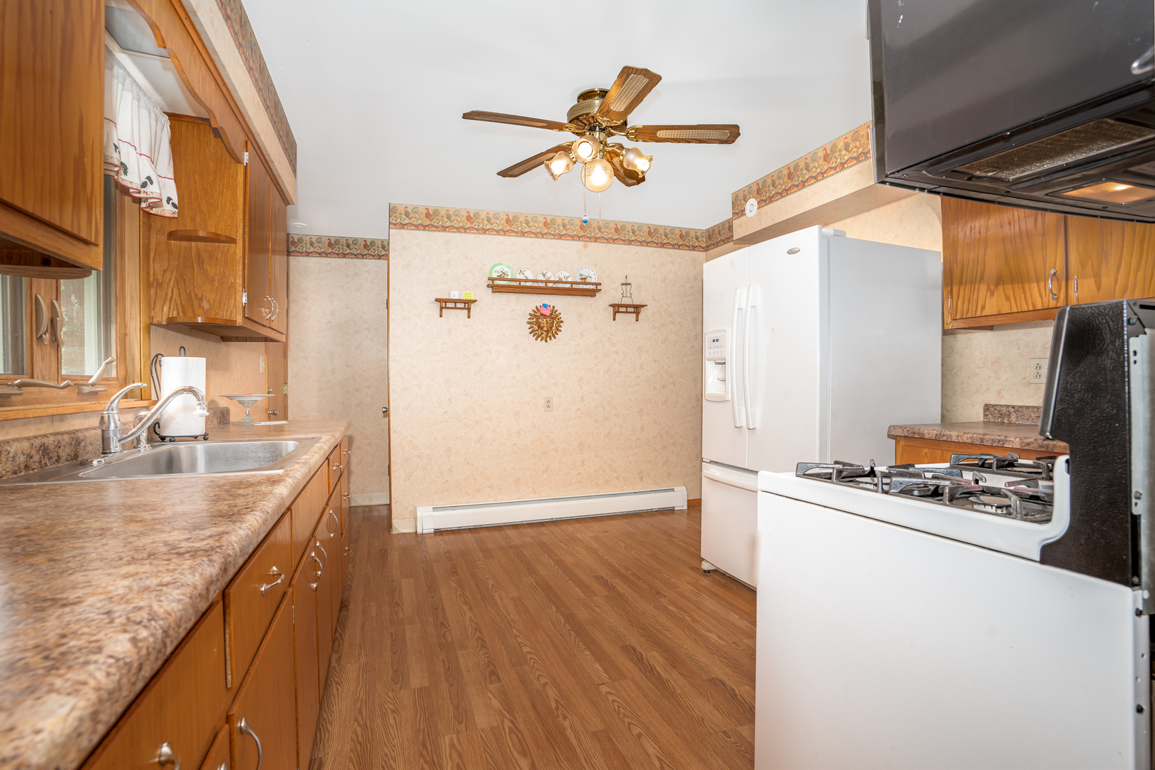 11025 Bryant Road Mokena, IL 60448 - Photo 10 of 21 a kitchen with stainless steel appliances granite countertop a refrigerator a stove and a sink with wooden floor
