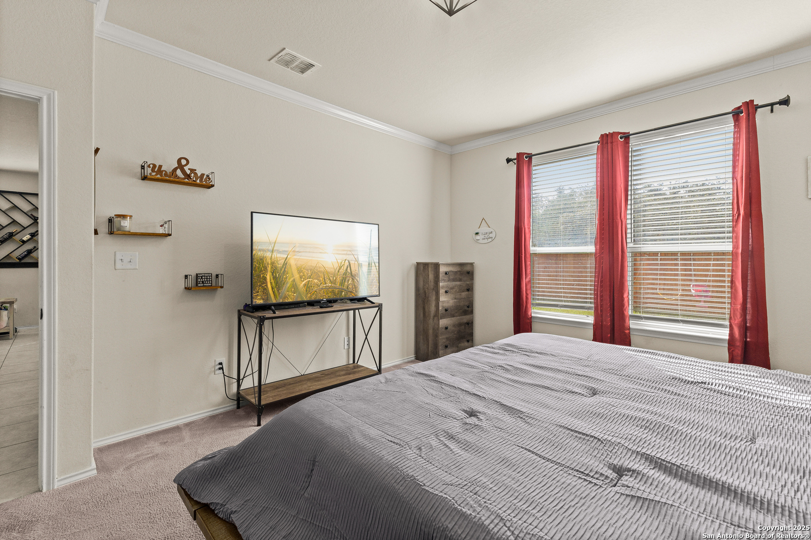 1447 Polydora San Antonio, TX 78245 - Photo 20 of 33 a bedroom with a bed and a flat screen tv