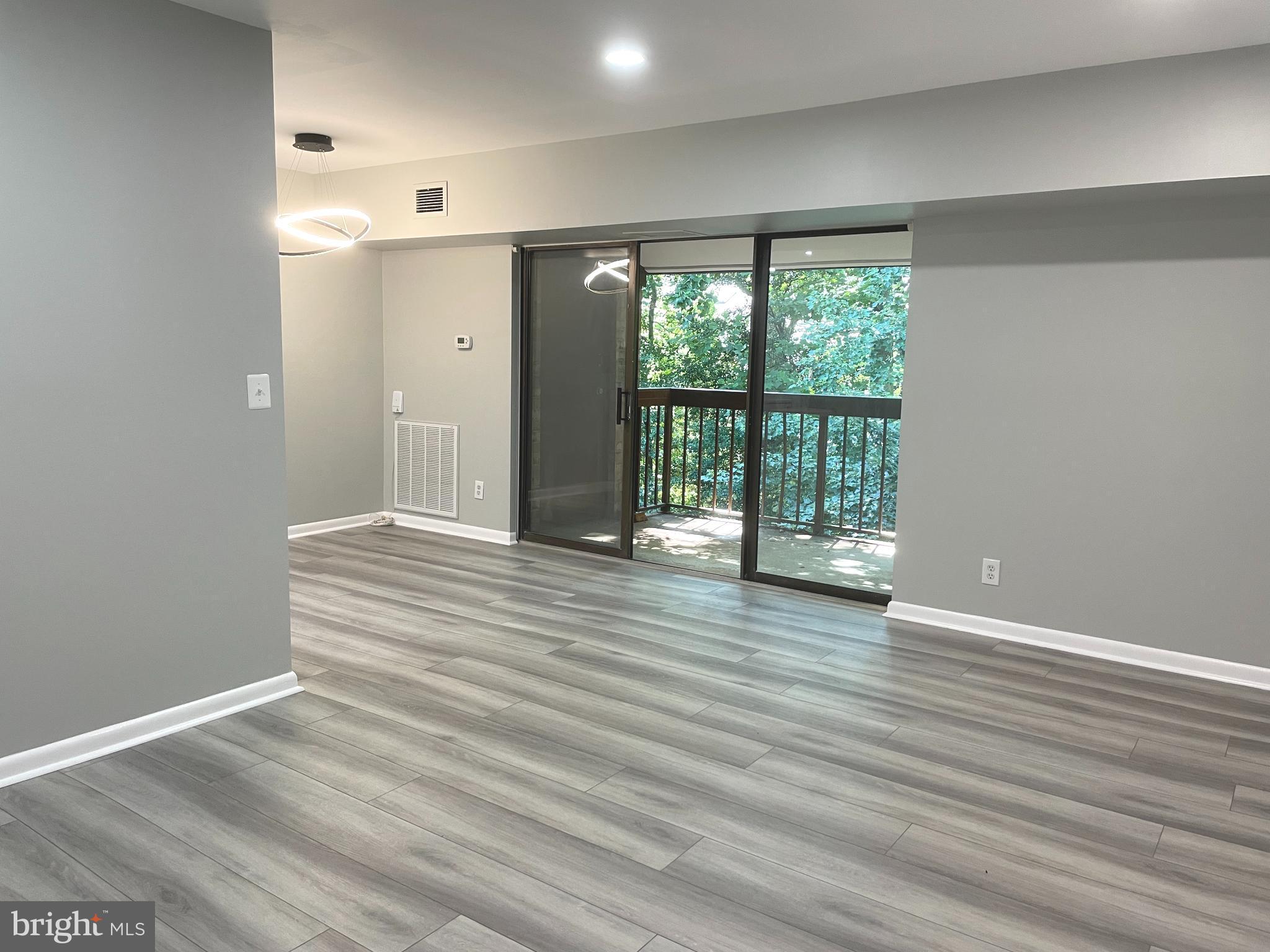 2214 Castle Rock Square, Unit 22C Reston, VA 20191 - Photo 12 of 32 View from LIVING ROOM to DR and balcony