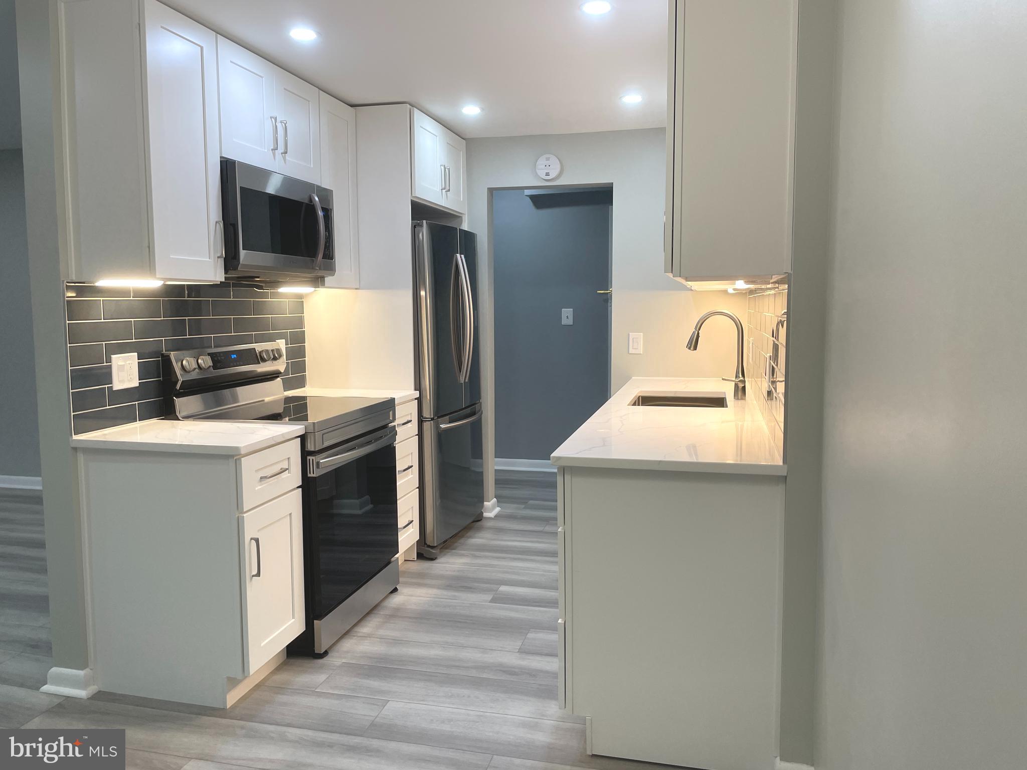 2214 Castle Rock Square, Unit 22C Reston, VA 20191 - Photo 5 of 32 View from DR to KITCHEN w/under cabinet lighting