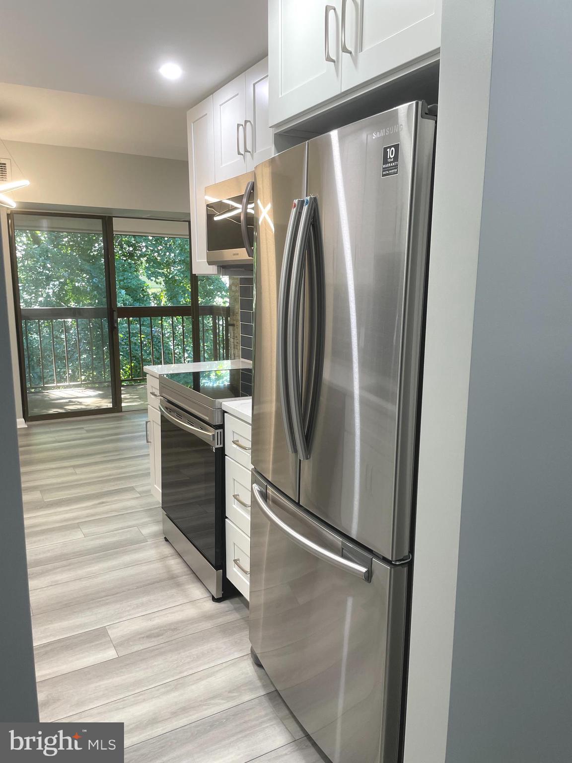 2214 Castle Rock Square, Unit 22C Reston, VA 20191 - Photo 8 of 32 KITCHEN w/view of balcony door & trees and nature