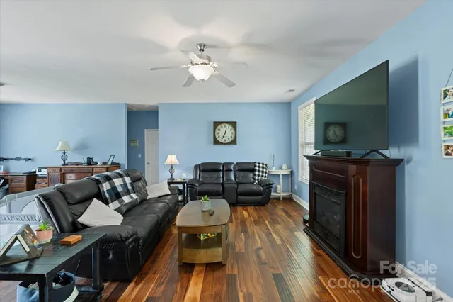 a living room with furniture and a book shelf