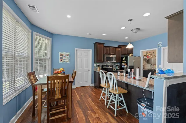 a kitchen with stainless steel appliances granite countertop sink stove and cabinets